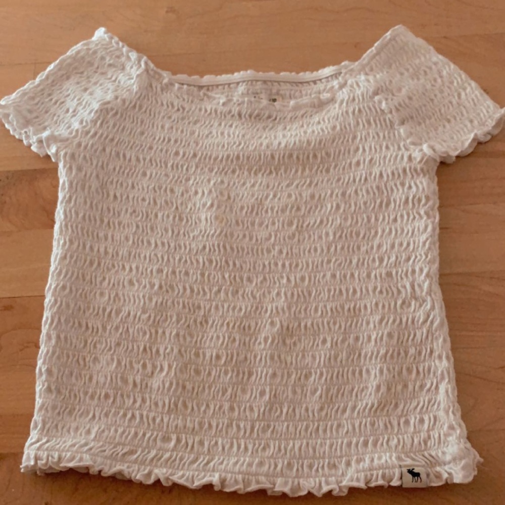 white off- the- shoulder smocked tee